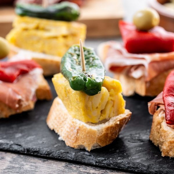Traditional Spanish pintxos on wooden table